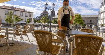 Camarero desinfectando una mesa de la terraza